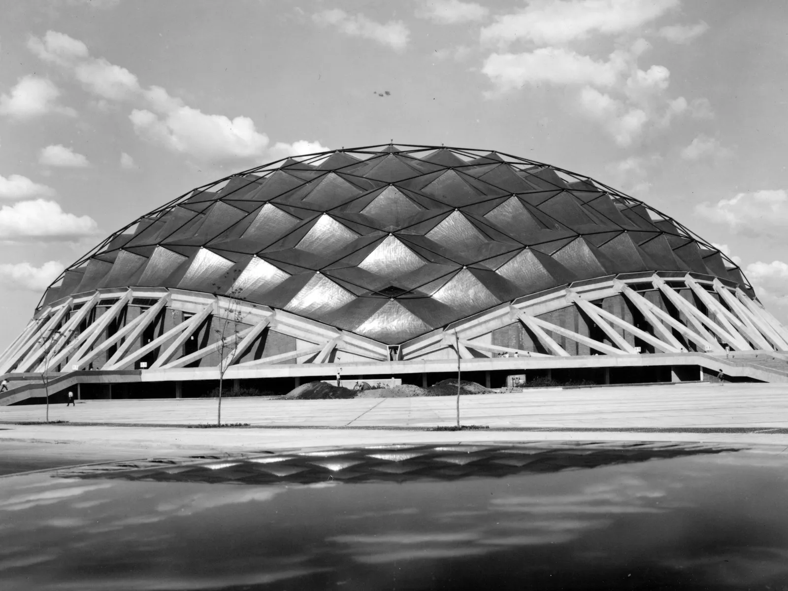 The newly completed Palacio de los Deportes: its copper geodesic dome over steel arches, reflected on the plaza.